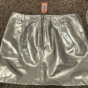 New with take. Mini faux leather with front zip